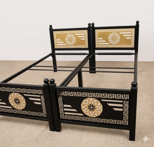 : Twin black metal bed frames featuring premium laser-cut gold contrast panels with a Greek key border and central geometric mandala rings, fabricated by Faisal Laser Works.