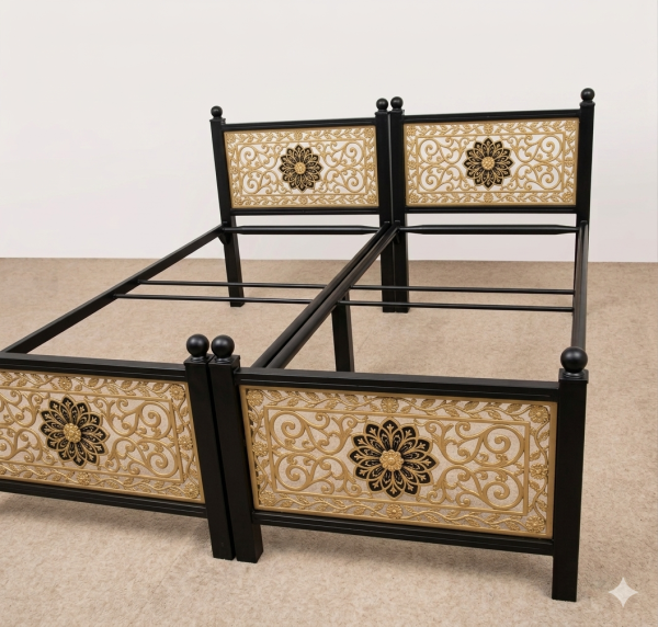 Luxury twin black metal bed frames featuring intricate laser-cut gold-finished panels with a royal floral vine pattern and a central blooming flower motif, manufactured by Faisal Laser Works.